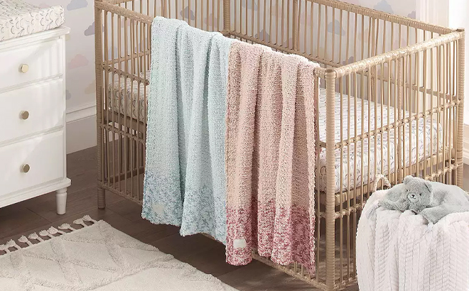 Koolaburra by UGG Baby Bryce Knit Blanket Hanging on a Baby Crib in Two Colors