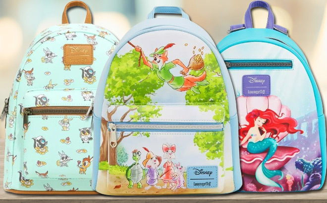 Three Loungefly Disney Backpacks on a Tabletop