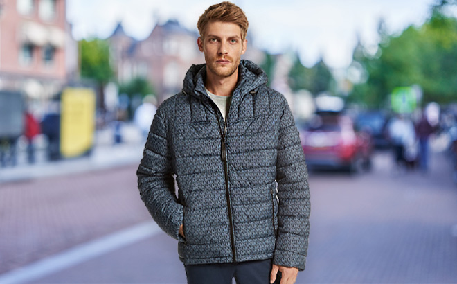 Man is Wearing Michael Kors Logo Print Quilted Puffer Jacket in Midnight Navy Color