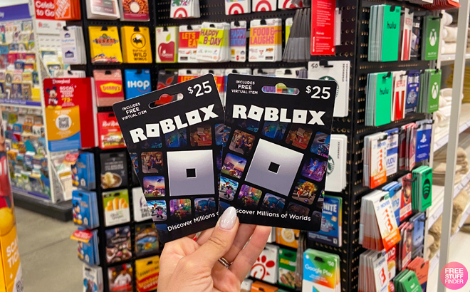 Person Holding Two Roblox Gift Cards