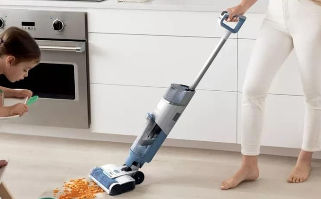 A Person Using a Shark HydroVac Cordless Pro XL Vaccuum in a Kitchen