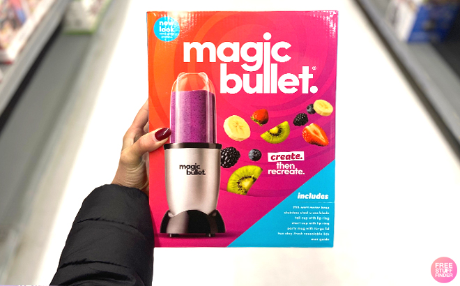 Woman holding a Magic Bullet Personal Blender in a box