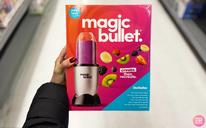 Woman holding a Magic Bullet in a box