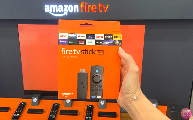 Woman holding an Amazon Fire TV Stick Lite
