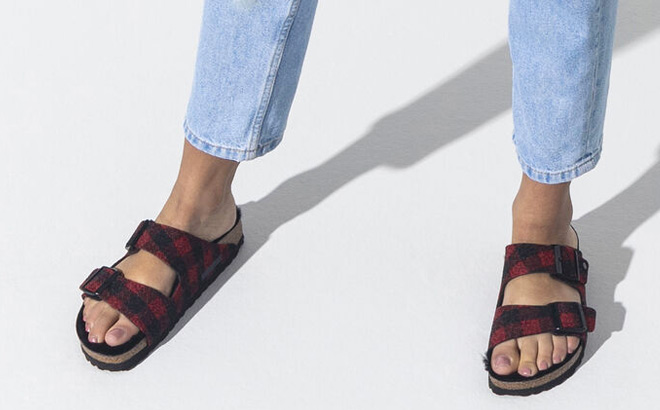 Woman is Wearing Birkenstock Arizona Shearling Plaid Sandal in Black and Red Color