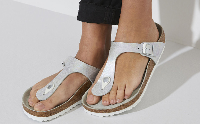 Woman is Wearing Birkenstock Gizeh Iridescent Thong Sandals in Iridescent Matcha Color