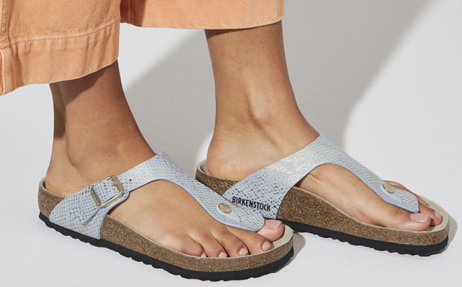 Woman is Wearing Birkenstock Gizeh Shiny Python Thong Sandals in Blue Python Color