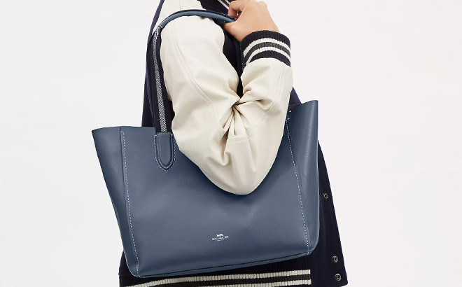 Woman is Wearing Coach Derby Tote in Light Mist Color