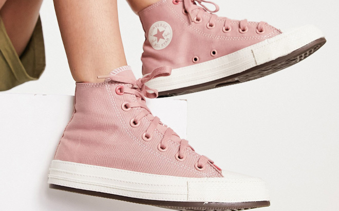 Woman is Wearing Converse Chuck Taylor All Star Sneakers in Pink Color