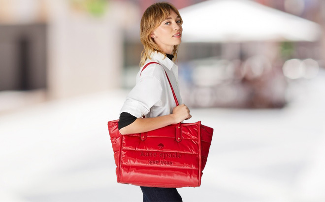 Woman is Wearing Kate Spade Ella Puffy Extra Large Tote in Candied Cherry Color