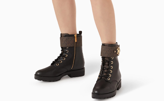 Woman is Wearing Michael Kors Womens Rory Lace Up Signature Strap Booties in Black and Brown Color