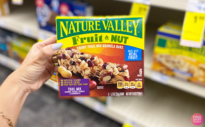 a Hand Holding Nature Valley Fruit and Nut Granola Bars Pack