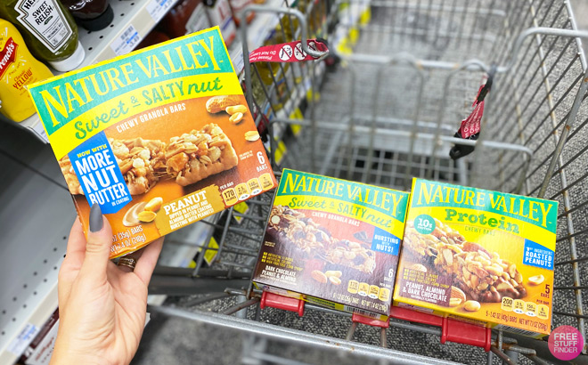 a Hand Holding Nature Valley Granola Bars Pack next to Nature Valley Packs in CVS Cart