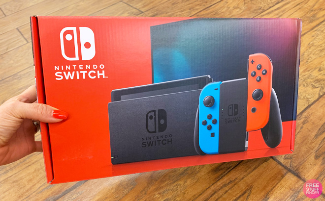 a Hand Holding Nintendo Switch in a Box
