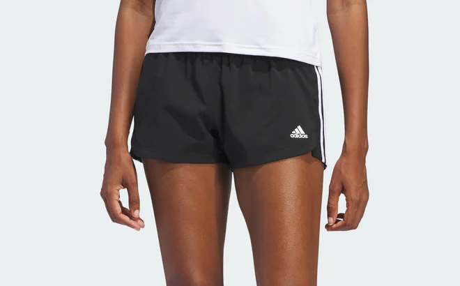 a Woman Wearing Adidas Womens Pacer 3 Stripes Woven Shorts