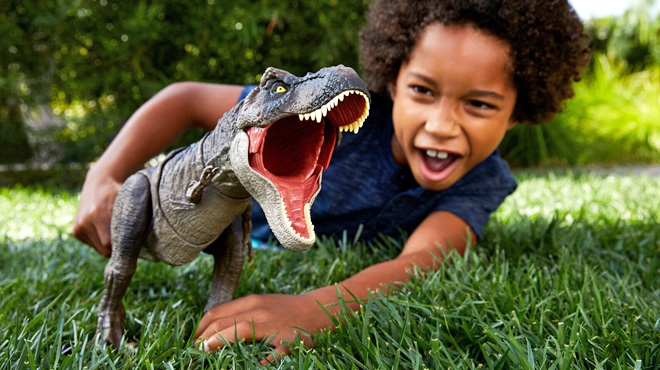 A Boy Playing with a Jurassic World Dominion Tyrannosaurus Rex Dinosaur Toy