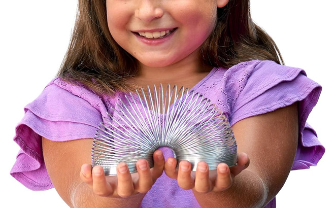 A Child Playing with the Original Slinky Metal Spring Toy