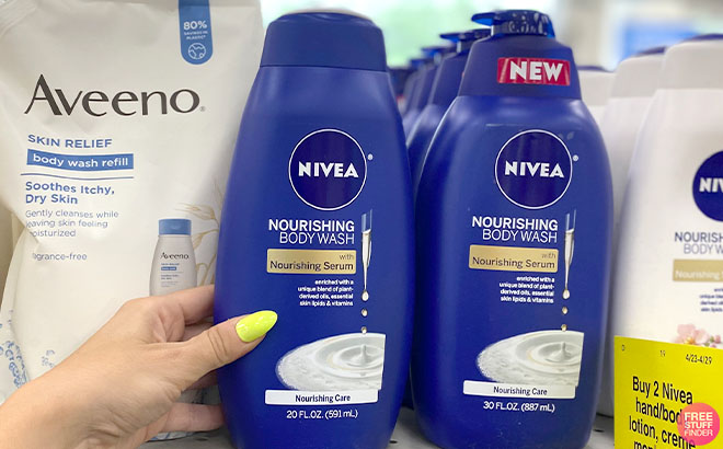 A Hand Holding a Nivea Body Wash on a Shelf