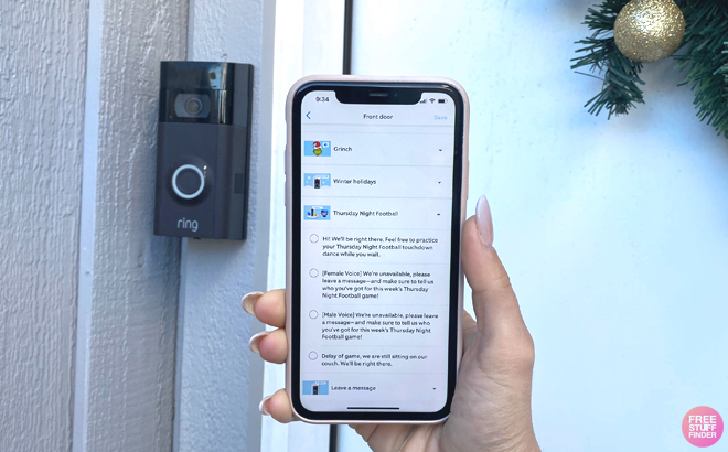 A Person Holding a Phone and a Ring Doorbell on the Wall