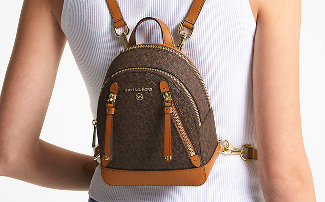 A Person Wearing Brown Michael Kors Mini Brooklyn Backpack A Person Wearing Brown Michael Kors Mini Brooklyn Backpack