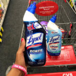 A person holding a Lysol Toilet Cleaner