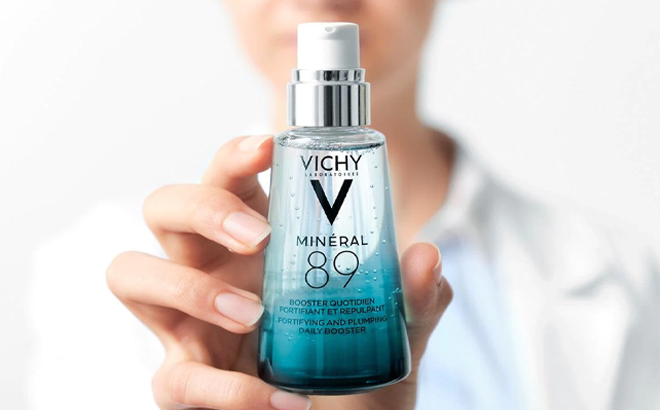 A person holding aaVichy Mineral 89 Facial Moisturizer