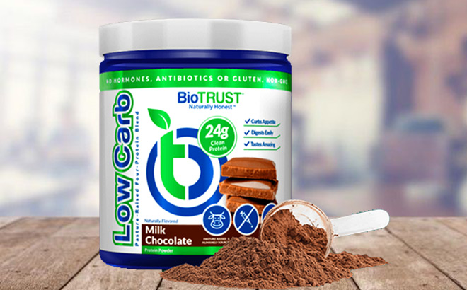 BioTrust Protein Tube next a Scoop of Protein Powder on a Tabletop