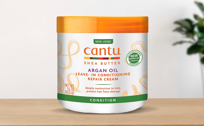 Cantu Leave In Conditioning Repair Cream with Argan Oil on a Wooden Table