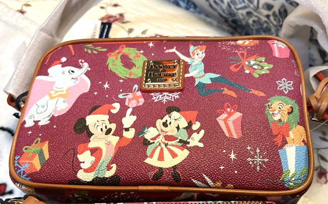 Disney Classics Christmas Dooney Bourke Camera Bag on a Bed
