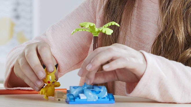 Girl Playing with Mega Pokemon PikachuS Beach Splash 79 Piece Action Figure Building Set