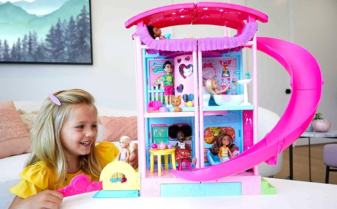 Girl Playing with the Barbie Chelsea Doll House