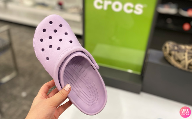 Hand Holding Crocs Kids Classic Clogs in Lavender Color
