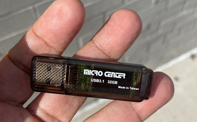 Hand Holding Micro Center Flash Drive