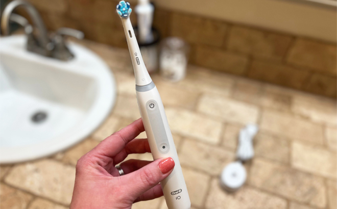 Hand Holding Oral B iO4 Electric Toothbrush