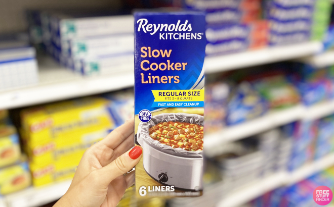 Hand Holding Reynolds Kitchens Slow Cooker Liners
