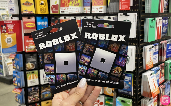 Hand Holding Roblox Gift Cards