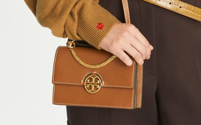 Hand Holding Tory Burch Miller Mini Leather Flap Bag