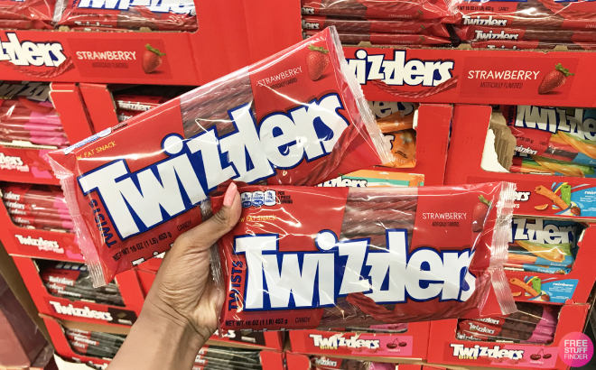 Hand Holding Two Bags of Twizzlers Twists Strawberry Flavor Candy