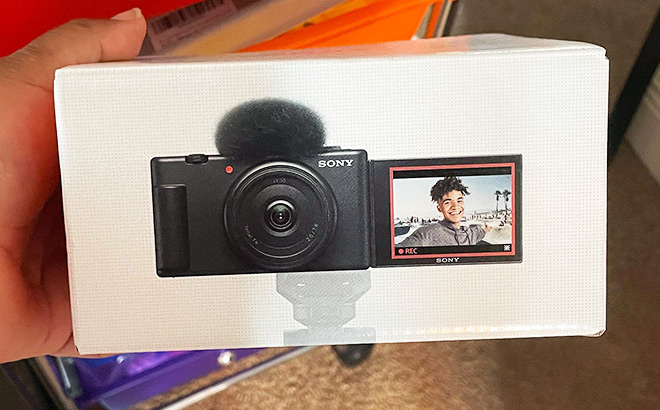 Hand Holding a Box of Sony ZV 1F Vlog Camera