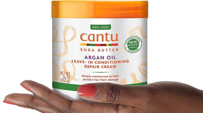 Hand Holding a Cantu Leave In Conditioning Repair Cream