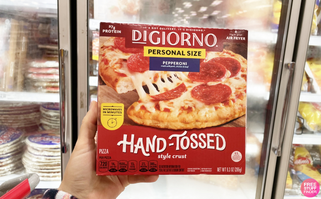 Hand Holding a DiGiorno Hand Tossed Frozen Pizza