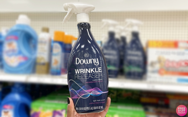 Hand Holding a Downy Wrinkle Releaser Fabric Spray