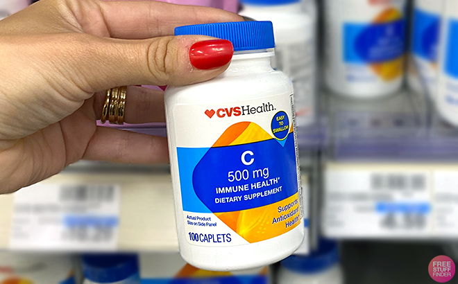 Hand holding one Bottle of CVS Health Vitamin C Tablets