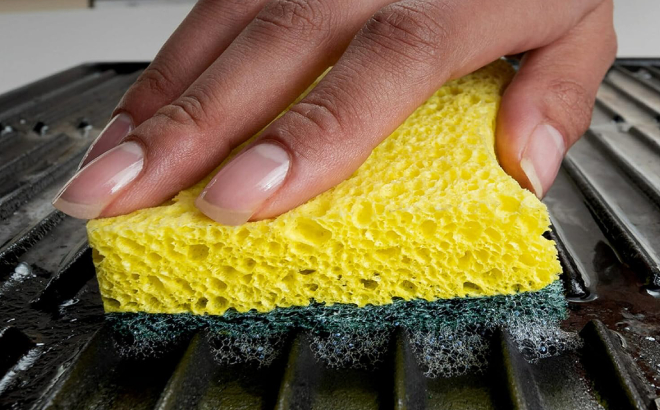 Lady Cleaning a Grill Using a Scotch Brite Heavy Duty Scrub Sponge