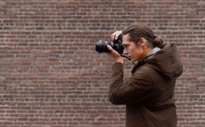 Man Capturing a Pic with Sony Alpha 7 III Video Camera Man Capturing a Pic with Sony Alpha 7 III Video Camera
