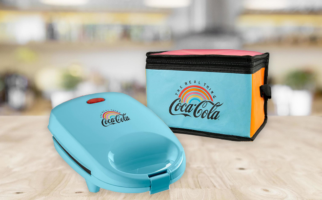 Nostalgia Coca Cola Sandwich Maker with Beverage Cooler Bag on a Table
