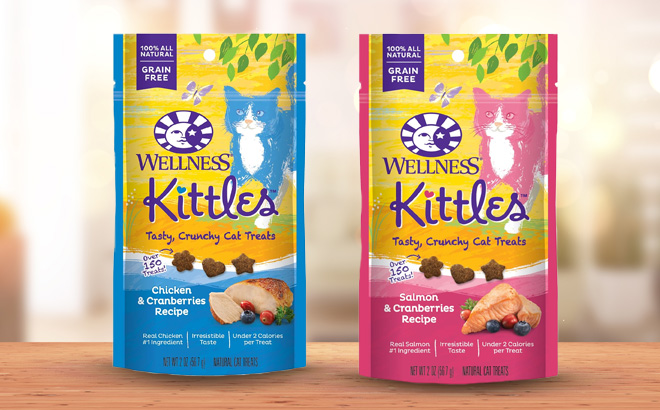 Two Different Flavors of Wellness Kittles Crunchy Natural Grain Free Cat Treats on a Wooden Table