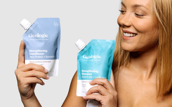 Woman Holding Geologie Shampoo and Conditioner Tubes