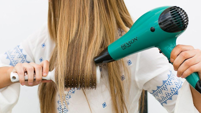 Woman Styling Her Hair with the Revlon Volume Booster Hair Dryer