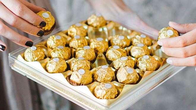 Women Getting Chocolates from the Ferrero Rocher 24 Count Gift Box Women Getting Chocolates from the Ferrero Rocher 24 Count Gift Box